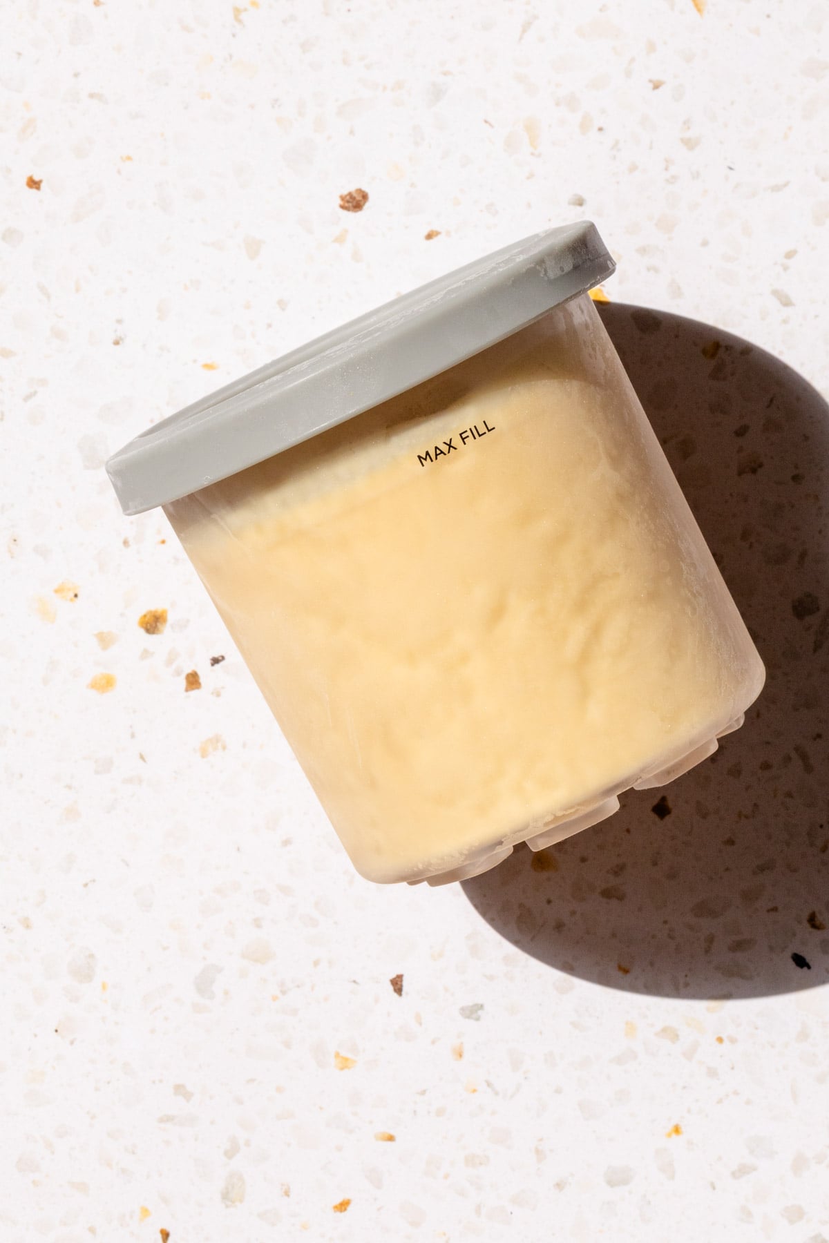 Frozen peanut butter ice cream in Ninja Creami pint