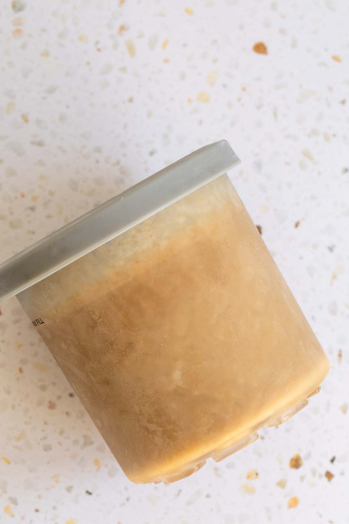 Frozen ice cream in Ninja Creami container
