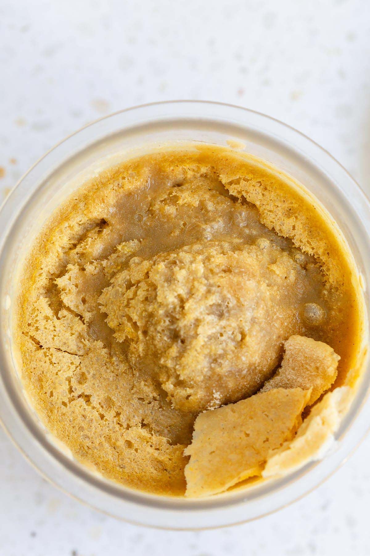 Frozen pumpkin ice cream in Ninja Creami container with lid off